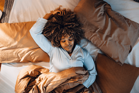 A person sleeping peacefully in bed
